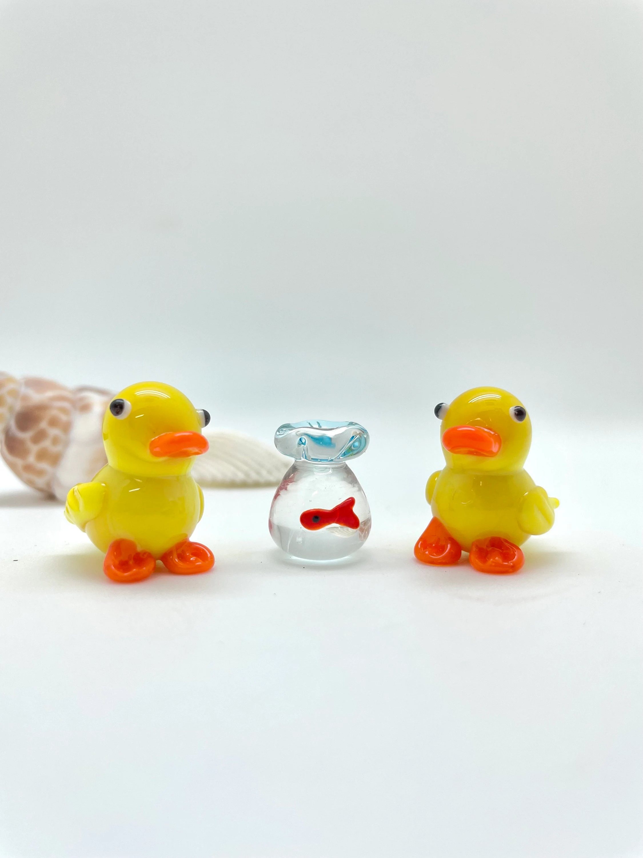 Hand-Blown Glass Duck Figurine - Yellow Duck Carrying a Fish Bag